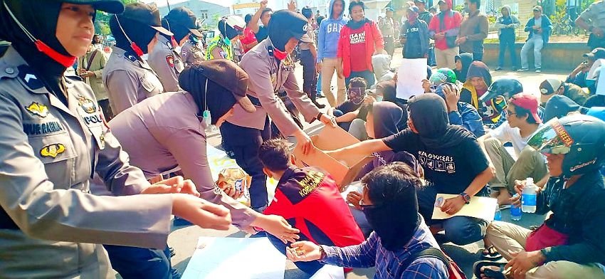 Dengan Humanis, Polwan Polres Gowa Bagikan Permen dan Air Minum ke Pengunjuk Rasa